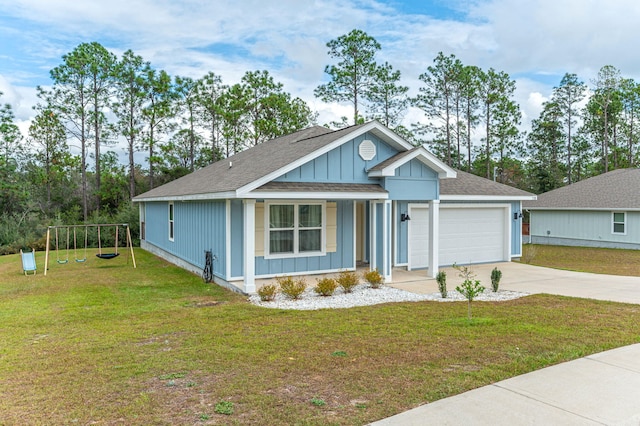 view of front of home featuring a playground, a front lawn, and a garage