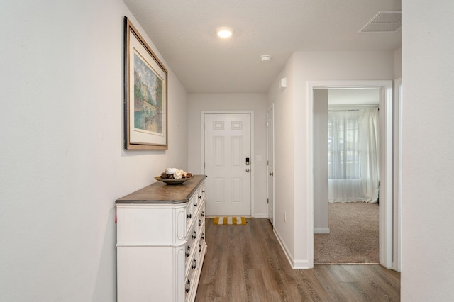 hall with wood-type flooring