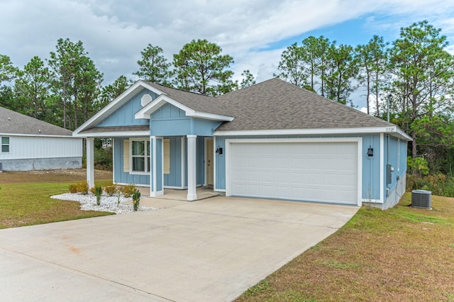 view of front facade with a garage, central AC unit, and a front lawn