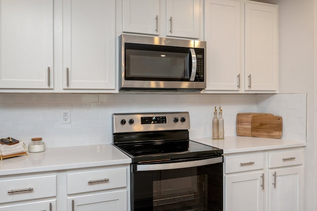 kitchen featuring white cabinets, backsplash, and appliances with stainless steel finishes