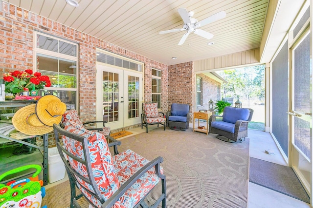 sunroom featuring french doors and ceiling fan