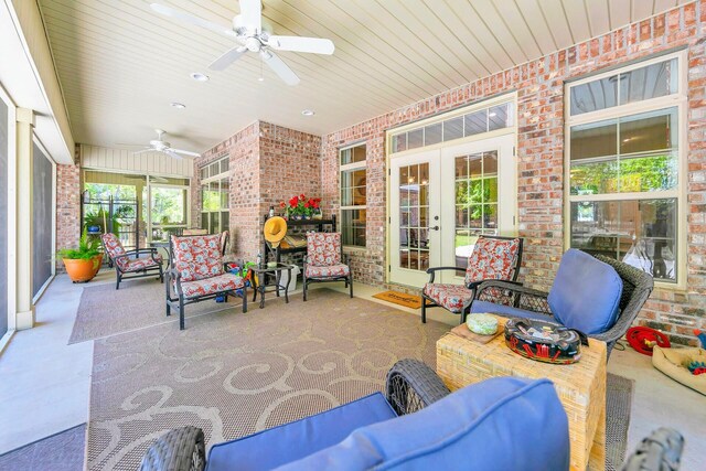 sunroom featuring french doors, ceiling fan, and wood ceiling