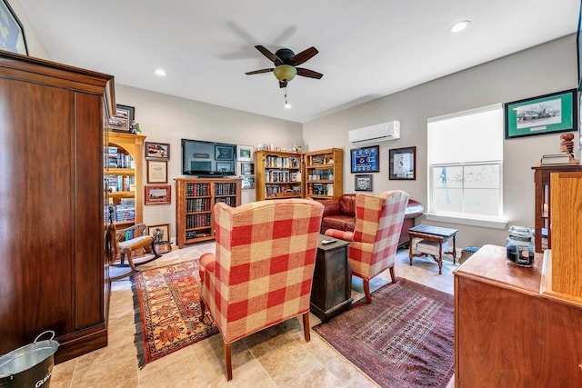 living room with a wall unit AC and ceiling fan