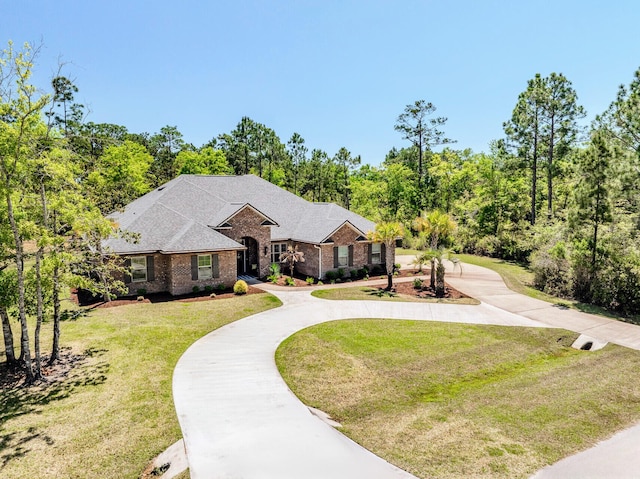 ranch-style house featuring a front lawn