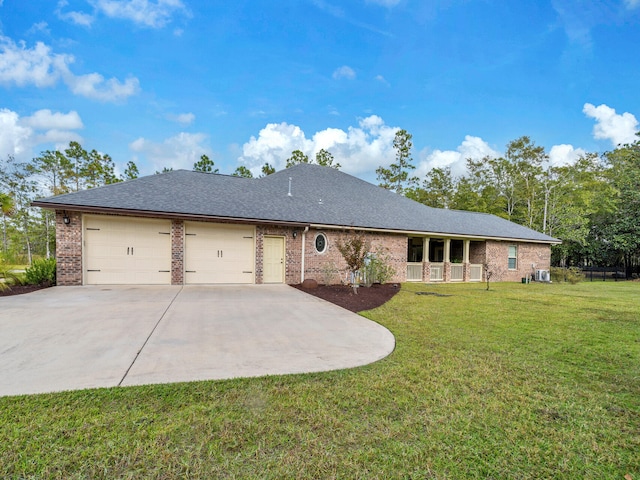 ranch-style home with a front lawn, central AC, and a garage