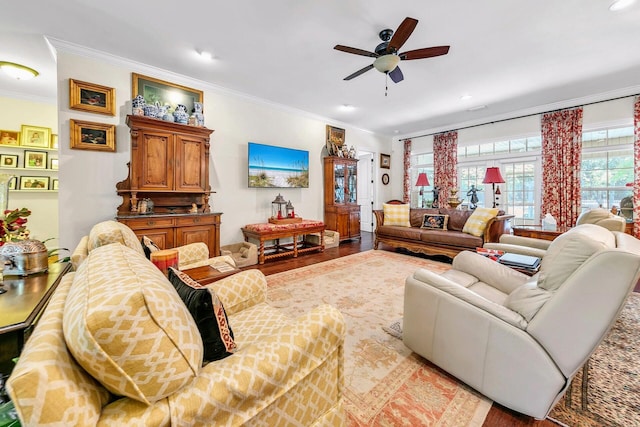 living room featuring ceiling fan, ornamental molding, and light hardwood / wood-style flooring