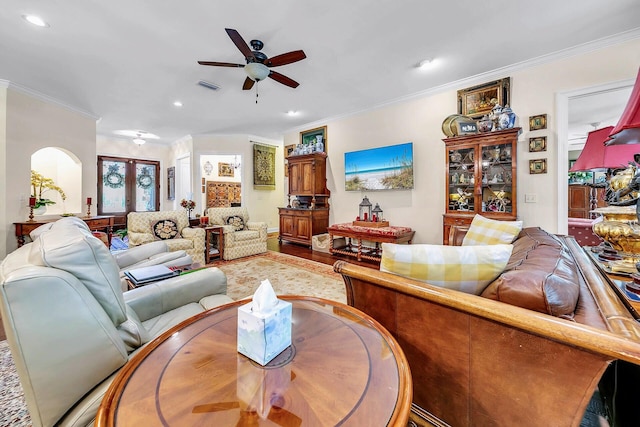 living room featuring crown molding, hardwood / wood-style floors, and ceiling fan