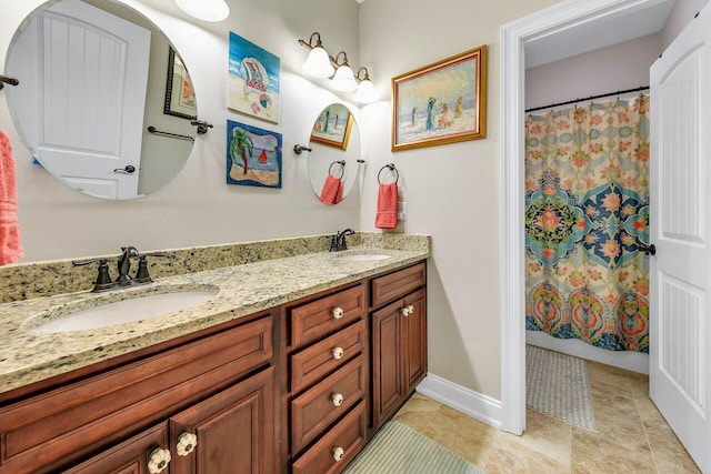 bathroom with vanity, curtained shower, and tile patterned flooring
