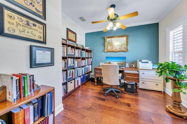 office area featuring dark wood-type flooring, crown molding, and ceiling fan