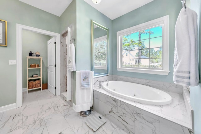 bathroom featuring tiled tub