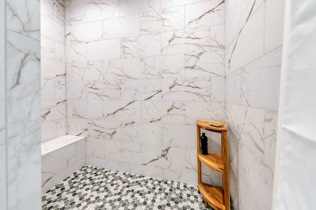 bathroom with a tile shower