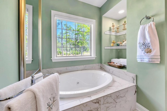 bathroom featuring tiled tub