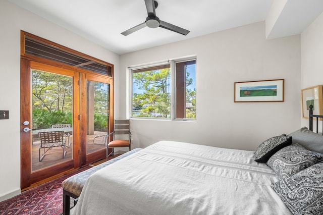 bedroom featuring wood-type flooring, multiple windows, access to outside, and ceiling fan