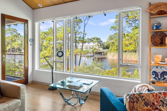 sunroom with vaulted ceiling, wooden ceiling, a water view, and a wealth of natural light