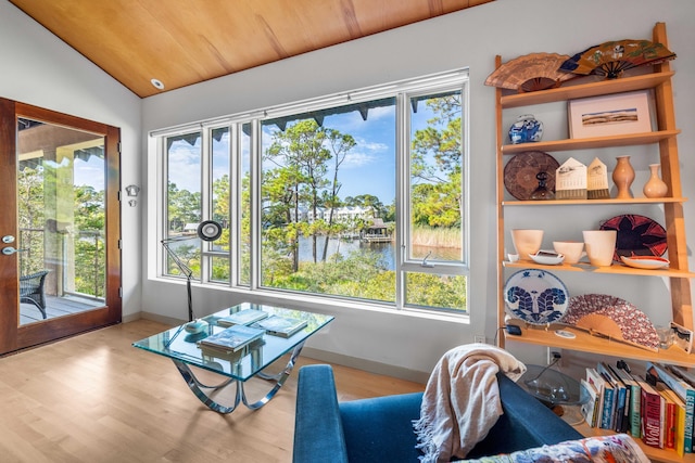 interior space featuring wood ceiling, a healthy amount of sunlight, lofted ceiling, and light hardwood / wood-style floors