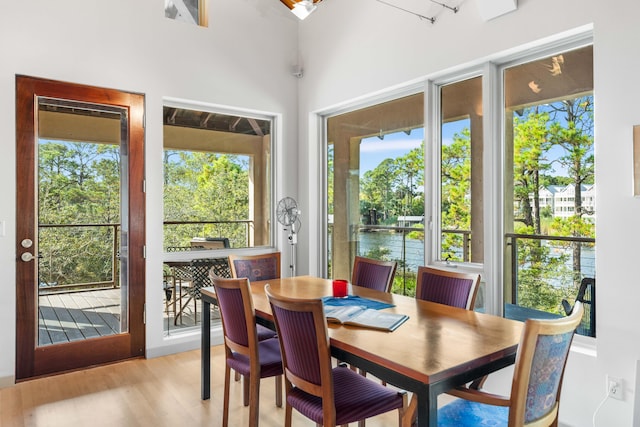 sunroom with a water view and a wealth of natural light