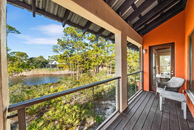 unfurnished sunroom featuring a water view and lofted ceiling with beams