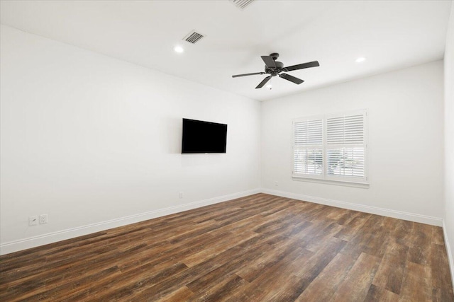 spare room with dark hardwood / wood-style floors and ceiling fan