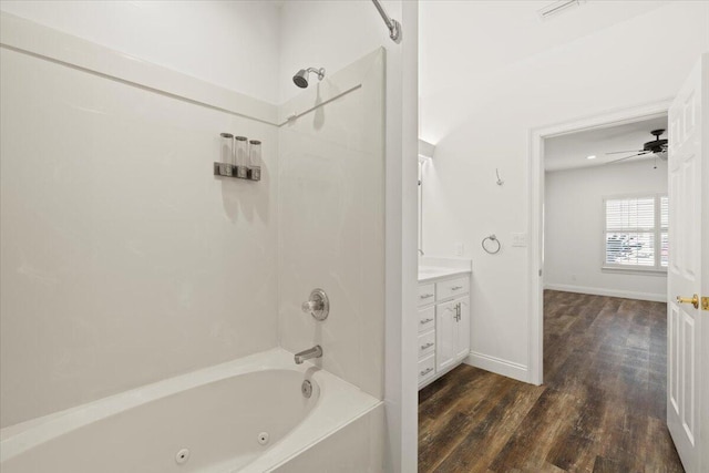 bathroom with vanity, ceiling fan, wood-type flooring, and tub / shower combination