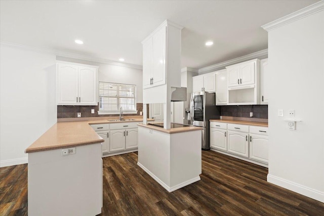 kitchen featuring dark hardwood / wood-style floors, a kitchen island, and white cabinets