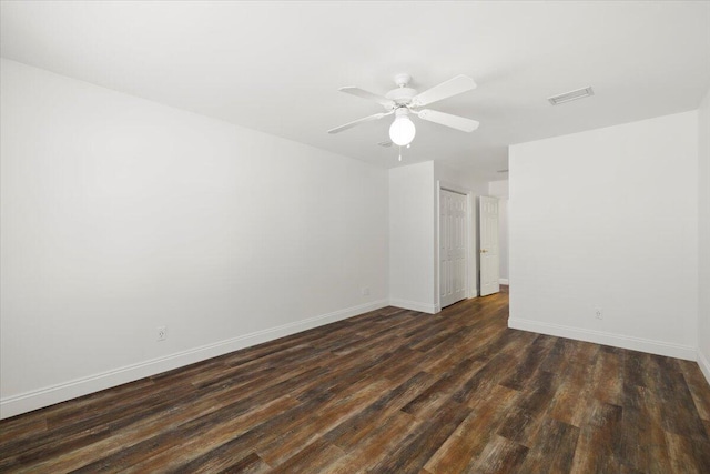 spare room featuring ceiling fan and dark hardwood / wood-style flooring