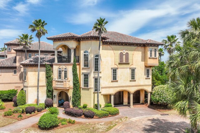 215 Rue St, Tropez, Miramar Beach, FL 32550 - view of front facade with a tile roof, stucco siding, decorative driveway, a balcony, and a carport