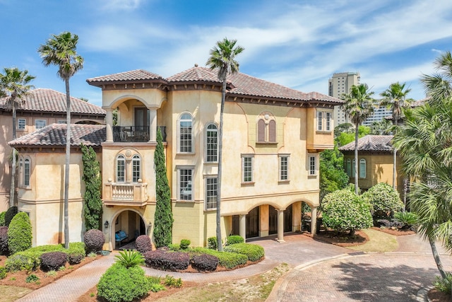 215 Rue St, Tropez, Miramar Beach, FL 32550 - view of front of house with a tile roof, a balcony, and stucco siding