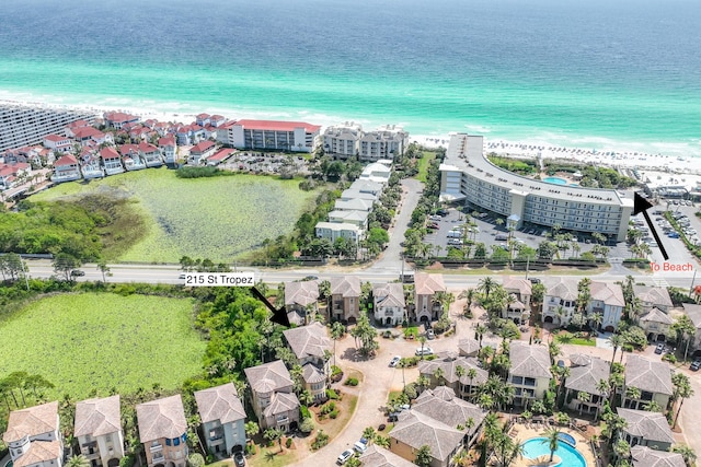 birds eye view of property with a water view and a view of the beach