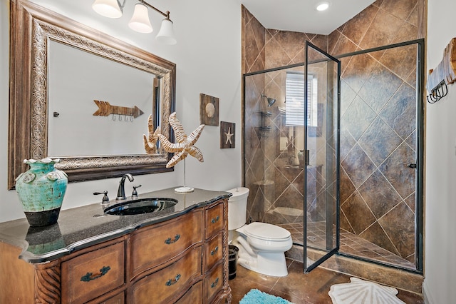 bathroom featuring vanity, toilet, walk in shower, and tile patterned flooring