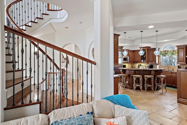 215 Rue St, Tropez, Miramar Beach, FL 32550 - living room with stone tile floors, recessed lighting, a tray ceiling, and stairs