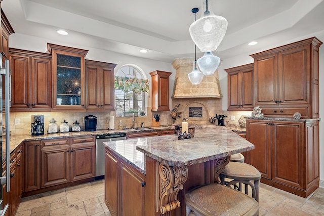 kitchen with dishwasher, a kitchen island, backsplash, and pendant lighting