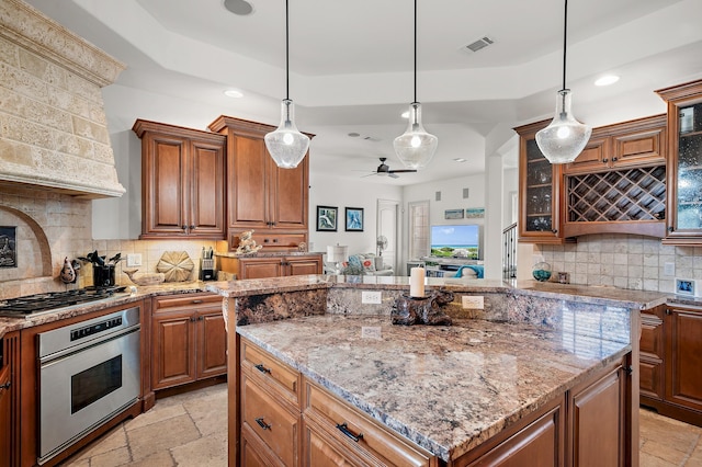 215 Rue St, Tropez, Miramar Beach, FL 32550 - kitchen with visible vents, appliances with stainless steel finishes, a center island, recessed lighting, and stone tile floors