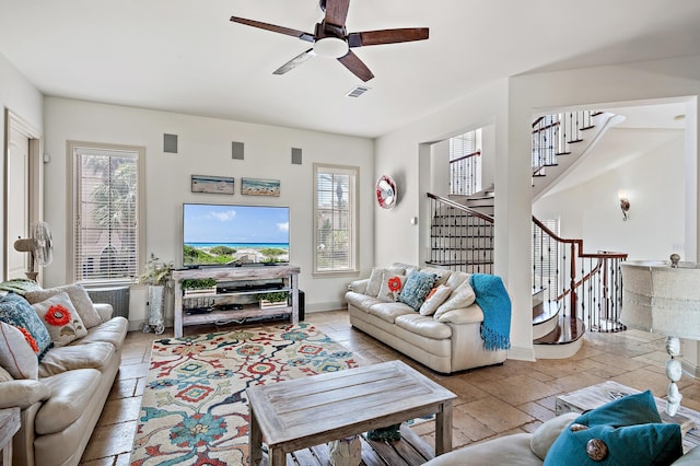 living room featuring ceiling fan and a wealth of natural light