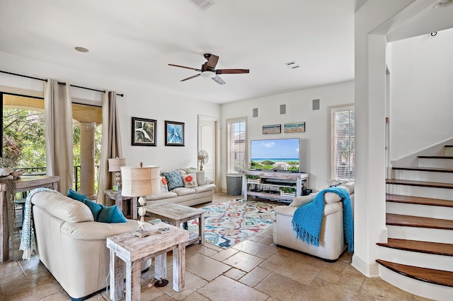 living room featuring plenty of natural light and ceiling fan