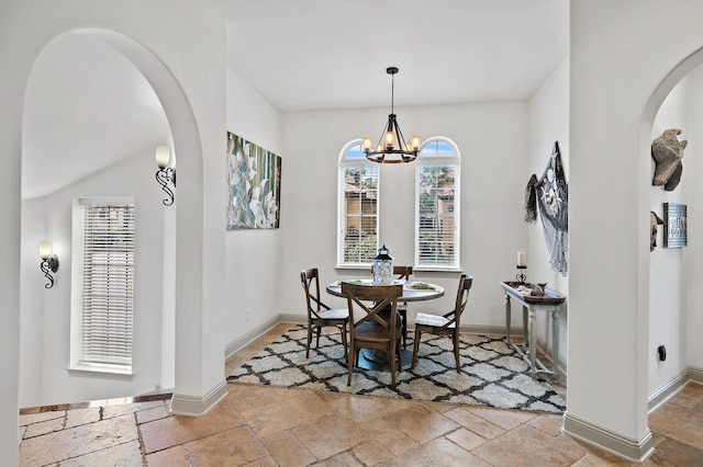 215 Rue St, Tropez, Miramar Beach, FL 32550 - dining room with baseboards, stone tile floors, arched walkways, and a healthy amount of sunlight