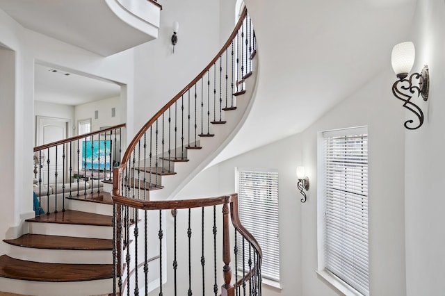 staircase featuring a high ceiling