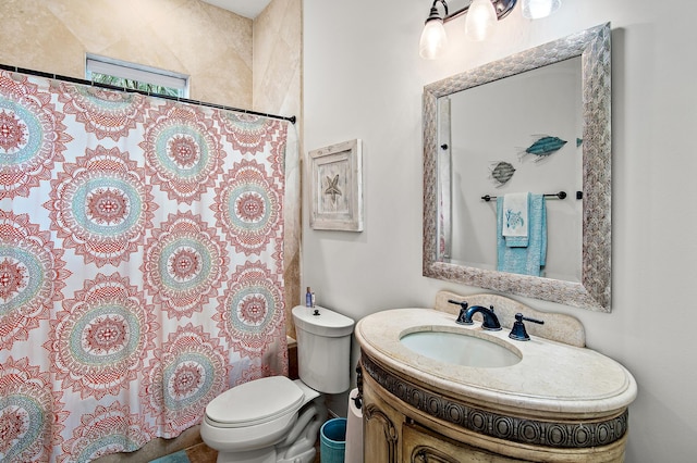 bathroom with toilet, curtained shower, and vanity