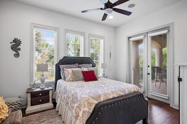 bedroom featuring dark wood-type flooring, multiple windows, access to outside, and ceiling fan