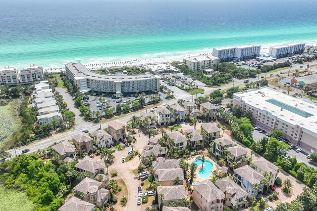 drone / aerial view with a water view and a beach view