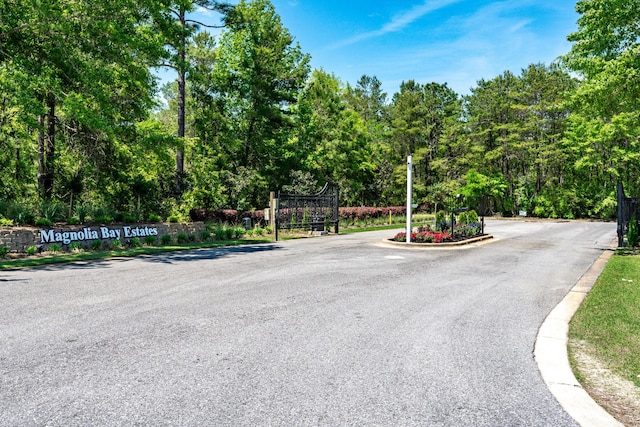 23 S J Hunters Way Lot 63, Freeport, FL 32439 - view of asphalt road featuring curbs and a gated entry