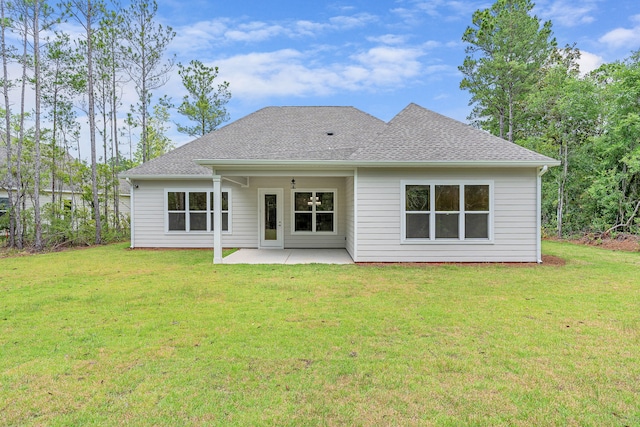 rear view of house featuring a lawn and a patio area