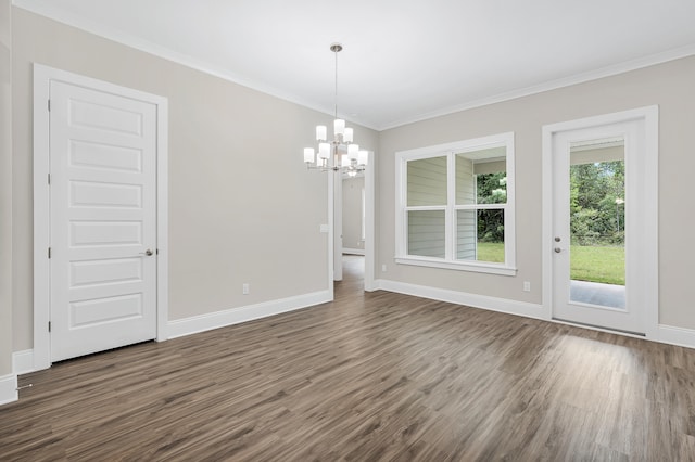 unfurnished dining area with a chandelier, crown molding, and dark wood-type flooring