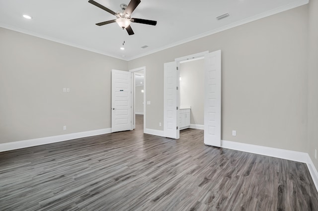 unfurnished bedroom featuring connected bathroom, dark hardwood / wood-style flooring, ceiling fan, and ornamental molding