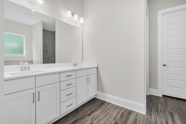 bathroom with a shower with door, vanity, and hardwood / wood-style flooring