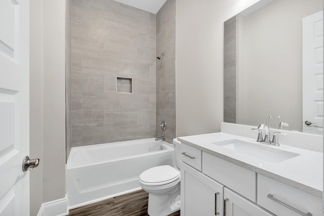 full bathroom with toilet, tiled shower / bath combo, hardwood / wood-style flooring, and vanity