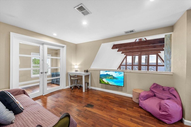 sitting room featuring french doors, dark hardwood / wood-style flooring, and plenty of natural light