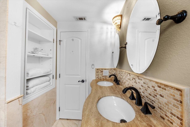 bathroom featuring tile walls and vanity