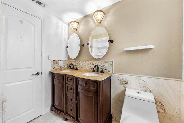 bathroom featuring tile walls, vanity, and toilet