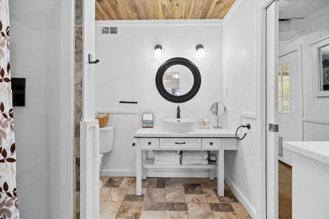 bathroom featuring vanity, toilet, and wooden ceiling