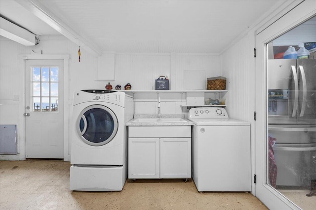 clothes washing area featuring cabinets and sink